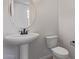 Clean powder room with a pedestal sink and toilet, showcasing modern fixtures and design at 18711 E Panchito Dr, Gold Canyon, AZ 85118