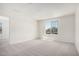 Spacious bedroom with soft carpet, white walls, a window, and an open doorway at 18746 E Panchito Dr, Gold Canyon, AZ 85118