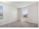 This is a well lit bedroom with two windows and neutral carpet at 18746 E Panchito Dr, Gold Canyon, AZ 85118