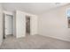 This bedroom has neutral carpet and a view to an ensuite bath at 18746 E Panchito Dr, Gold Canyon, AZ 85118
