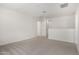 Open bonus room features neutral carpet, bright white walls, and a view of another room at 18746 E Panchito Dr, Gold Canyon, AZ 85118