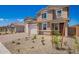 Inviting two-story home with a neatly landscaped front yard and a charming covered entryway at 18746 E Panchito Dr, Gold Canyon, AZ 85118