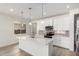 Modern kitchen features white cabinets, stainless steel appliances, quartz countertops and pendant lighting at 18746 E Panchito Dr, Gold Canyon, AZ 85118