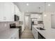 Spacious kitchen with white cabinets, stainless steel appliances, gray backsplash, and modern fixtures at 18746 E Panchito Dr, Gold Canyon, AZ 85118