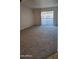 Spacious living room with carpeted floors and sliding glass door at 3131 W Cochise Dr # 149, Phoenix, AZ 85051