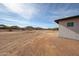 Exterior view of the home's side yard, showcasing the natural desert landscape and blue skies at 3295 W Mesquite St, Phoenix, AZ 85086