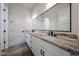 Modern bathroom featuring a double sink vanity with granite countertops and dark hardware at 3295 W Mesquite St, Phoenix, AZ 85086