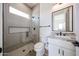 Modern bathroom featuring granite countertop vanity, frameless shower glass, and neutral tile at 3295 W Mesquite St, Phoenix, AZ 85086