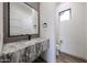 Elegant powder room showcases a modern sink with granite countertop and decorative backsplash at 3295 W Mesquite St, Phoenix, AZ 85086