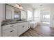 Elegant bathroom with a double sink vanity, large mirror, freestanding tub and a walk-in shower at 3295 W Mesquite St, Phoenix, AZ 85086