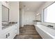 Luxurious bathroom featuring freestanding tub, wood-look tile, and dual vanities at 3295 W Mesquite St, Phoenix, AZ 85086