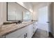 Bathroom featuring a double sink vanity with a large mirror and granite countertops at 3295 W Mesquite St, Phoenix, AZ 85086