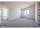 Bedroom with gray carpet, white walls, and an exterior view through the black framed window at 3295 W Mesquite St, Phoenix, AZ 85086