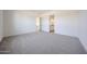 Spacious bedroom features neutral carpet, an open doorway, and natural light at 3295 W Mesquite St, Phoenix, AZ 85086