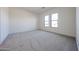 Bright bedroom with plush carpeting and two windows offering natural light at 3295 W Mesquite St, Phoenix, AZ 85086