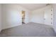 Bedroom featuring neutral carpet, white walls, and a glimpse into the ensuite bathroom at 3295 W Mesquite St, Phoenix, AZ 85086