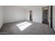 Bedroom featuring neutral carpet and a doorway leading into the ensuite bathroom at 3295 W Mesquite St, Phoenix, AZ 85086