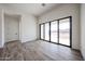 Neutral bedroom featuring sliding glass doors to a private outdoor space and wood-look tile at 3295 W Mesquite St, Phoenix, AZ 85086