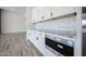 Modern kitchen features white cabinets, stainless steel Wolf oven, and subway tile backsplash at 3295 W Mesquite St, Phoenix, AZ 85086