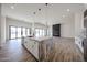 Stylish kitchen island with stone countertop in an open floorplan featuring wood-look floors and a fireplace at 3295 W Mesquite St, Phoenix, AZ 85086