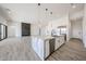 Modern kitchen island with marble countertops, stainless steel appliances, open layout to living area with fireplace at 3295 W Mesquite St, Phoenix, AZ 85086