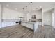 Open concept kitchen with white cabinetry, a large island, stainless steel appliances, and sleek pendant lights at 3295 W Mesquite St, Phoenix, AZ 85086