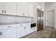 Modern kitchen features white cabinets, stainless steel appliances, and subway tile backsplash at 3295 W Mesquite St, Phoenix, AZ 85086