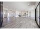 Spacious living area featuring an open layout to the kitchen, wood-look floors, and modern design elements at 3295 W Mesquite St, Phoenix, AZ 85086