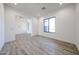 Bright living room with wood-look tile floors, large windows, and open layout to other rooms at 3295 W Mesquite St, Phoenix, AZ 85086