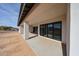 Covered outdoor patio that overlooks the landscape and home exterior with sliding glass doors at 3295 W Mesquite St, Phoenix, AZ 85086