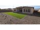 A large backyard with artificial turf and low maintenance landscape, perfect for outdoor entertaining at 6829 N 190Th Dr, Waddell, AZ 85355