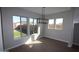 Inviting dining area bathed in natural light with three large windows overlooking the yard at 6829 N 190Th Dr, Waddell, AZ 85355