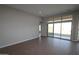 Bright living room with wood-look tile flooring and sliding glass doors leading to the backyard at 6829 N 190Th Dr, Waddell, AZ 85355