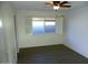 Bright bedroom featuring wood-look floors and window shutters at 13218 W Castlebar Dr, Sun City West, AZ 85375