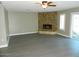 Living room with stone fireplace and sliding glass doors at 13218 W Castlebar Dr, Sun City West, AZ 85375