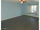 Spacious living room with light blue walls and wood-look floors at 13218 W Castlebar Dr, Sun City West, AZ 85375