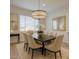 Elegant dining room featuring a modern chandelier, dining table, and stylish chairs at 2228 E Isaiah Ave, Gilbert, AZ 85298