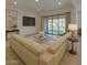 Bright living room features a large sectional sofa and sliding glass doors to the backyard at 2228 E Isaiah Ave, Gilbert, AZ 85298