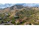 Aerial view of the home showcasing the tile roof, pool, landscaping and mountain views at 42383 N 111Th Pl, Scottsdale, AZ 85262