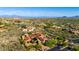 Breathtaking aerial view captures the estate with its lush landscaping, swimming pool, and desert vistas at 42383 N 111Th Pl, Scottsdale, AZ 85262