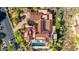 Expansive estate with red tile roof, multiple buildings, pool, courtyard and lush desert landscaping at 42383 N 111Th Pl, Scottsdale, AZ 85262