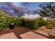 Stylish backyard with stone patio, lush greenery, and potted plants for a serene outdoor space at 42383 N 111Th Pl, Scottsdale, AZ 85262