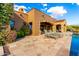 Resort-style backyard with pool, stone patio, and comfortable lounge chairs for ultimate relaxation at 42383 N 111Th Pl, Scottsdale, AZ 85262