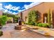Beautiful courtyard featuring a fire pit, lush greenery, and stone paving, perfect for outdoor relaxation at 42383 N 111Th Pl, Scottsdale, AZ 85262