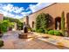 Charming courtyard features a fire pit, lush greenery, and artistic decor, creating a serene outdoor space at 42383 N 111Th Pl, Scottsdale, AZ 85262
