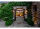 Grand entrance with iron gates, stone archway, and beautiful flowering vines at 42383 N 111Th Pl, Scottsdale, AZ 85262