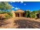 Charming home featuring a brick driveway, stone accents, and a pergola-covered garage, adding character and curb appeal at 42383 N 111Th Pl, Scottsdale, AZ 85262