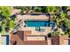 Aerial shot of a luxurious pool area with stylish seating and a bocce ball court at 42383 N 111Th Pl, Scottsdale, AZ 85262