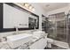 Modern bathroom featuring double sinks, granite counters, and a glass-enclosed shower at 520 S Brett St, Gilbert, AZ 85296