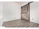 Bedroom with vinyl floors and a rustic sliding barn door at 520 S Brett St, Gilbert, AZ 85296